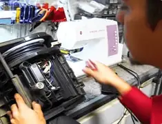Vacuum repair technician servicing internal components on a workbench in Myrtle Beach, SC