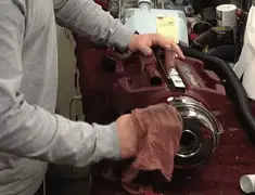 Vacuum repair technician cleaning and servicing a vacuum motor in Myrtle Beach, SC