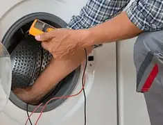Washing machine repair technician testing a front-load washer with diagnostic tools in Myrtle Beach, SC