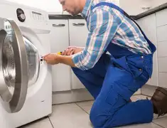 Washing machine repair technician servicing a front-load washer in Myrtle Beach, SC