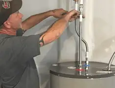 Water heater repair technician tightening supply line connections in Myrtle Beach, SC